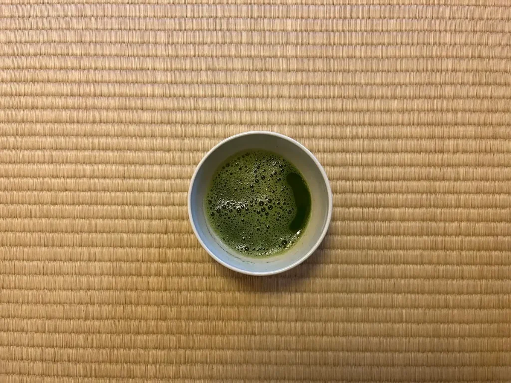 A bowl of freshly prepared matcha on tatami.